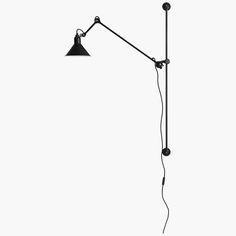 a black and white photo of a floor lamp on a white background with the light turned off