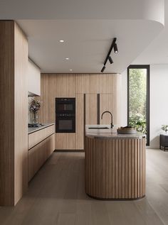 a modern kitchen with wooden cabinets and an island