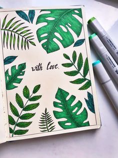 an open notebook with green leaves and the words with love written on it next to two markers