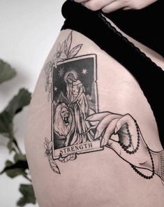 a woman's thigh with a tattoo on it that has an image of the virgin mary