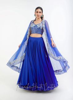 Royal Blue Color Skirt with Crop Top – Panache Haute Couture Blue Cape Sleeve Sets For Reception, Blue Sets With Sheer Dupatta And Cape Sleeves, Blue Embellished Georgette Lehenga, Blue Lehenga With Cape Sleeves And Dupatta, Blue Georgette Lehenga With Cape Sleeves, Blue Georgette Sharara For Reception, Blue Embellished Georgette Sets, Blue Lehenga With Cape Sleeves For Wedding, Party Blue Choli With Cape Sleeves