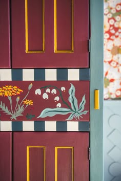 the door is painted with flowers and leaves