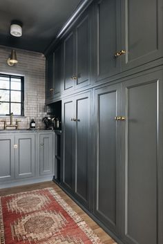 Moody kitchen scullery with dark gray cabinetry and mottled brass hardware. Terracotta floor runner. Bronze metallic tile for wall and backsplash. Ribbed Tile, Jean Stoffer Design, Stoffer Home, Jean Stoffer, House Pantry, Japanese Home Design, Coastal Bathroom, Scandinavian Minimalist, Coastal Bathrooms