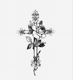 a black and white drawing of a cross with flowers