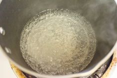 a pot filled with boiling water on top of a stove