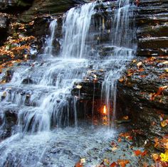 there is a light that is in the middle of some water cascadings