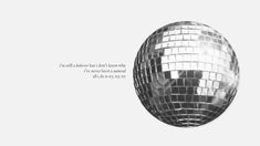 a silver disco ball with a quote on it