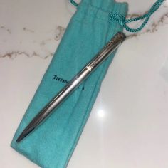 a pen sitting on top of a blue bag