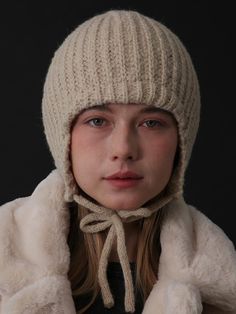 a woman wearing a white hat and scarf