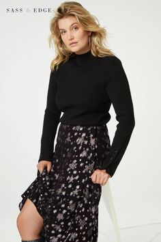 This A-line skirt features shimmering metallised fibres and is finished with a special gold metallic flower button for an extra touch of sophistication. The side zip and hook and eye fastening provide a secure fit, Plain Black Top, Flower Button, Skirt With Buttons