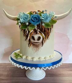 a cake decorated with flowers and a cow's head