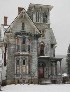 an old house with snow on the ground