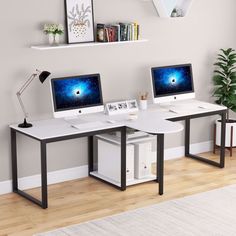 two computer monitors sitting on top of a white desk