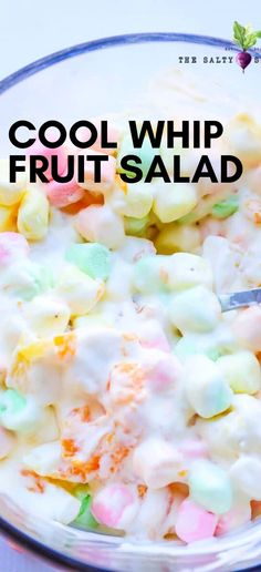 a bowl full of fruit salad with the words cool whip fruit salad on top and below