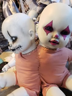 two creepy dolls sitting next to each other