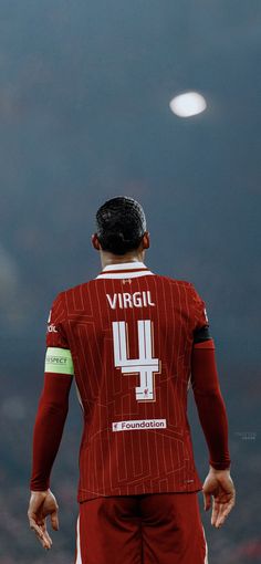 the back of a soccer player's jersey with his hands on his hips and head