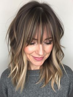 This modern take on the layered shag includes subtle highlights that bring brightness and depth to the hair. The fringe is gently textured, blending seamlessly with the rest of the layers. This cut works well for medium-thick hair, creating a flattering shape for round face shapes. The soft waves and delicate layers make it a versatile style for those looking for a balanced, everyday look with a touch of sophistication. Mushroom Brown Hair With Bangs, Long Bob Hairstyles With Fringe, Shag Highlights, Ombre Hair With Fringe, Medium Shag With Curtain Bangs, Shag Haircut With Fringe, Shag Bob With Bangs, Fall 2024 Hair Trends Haircuts, Highlights With Bangs