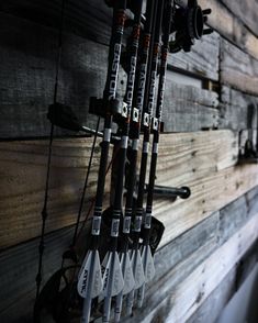 several skis and poles are hanging on the wall