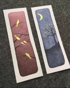 two bookmarks with birds on them sitting next to each other in front of a carpeted floor