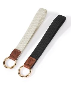 the black and white belt has two gold rings on one side, and an o - ring