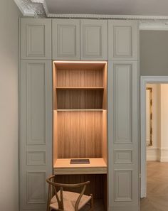 an empty room with a desk and chair next to the closet doors that are open