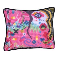 a pink and black pillow with an image of a woman's face on it