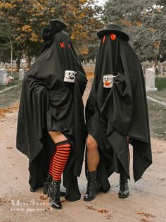 two people dressed up in black and red