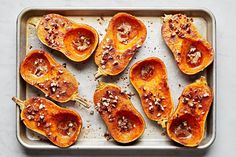 baked sweet potatoes on a baking sheet ready to be cooked in the oven for dinner