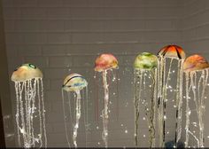 several different types of jellyfish floating in the water with bubbles coming out of them