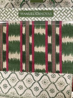 the packaging for manuel canvass is shown in green, red and white stripes with snowflakes on them