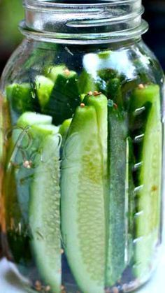 pickled cucumbers in a mason jar on a table