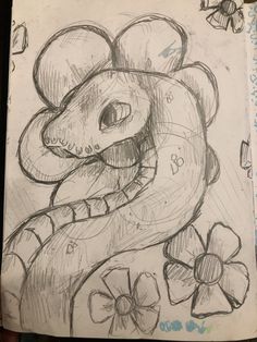 a drawing of a snake with flowers on it's head and an eyeball in its mouth