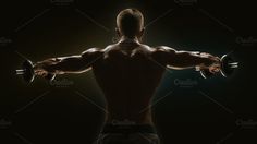 a man doing exercises with dumbbells in front of a dark background, back view