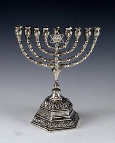 a silver menorah with five candles on it