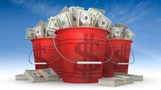 two buckets filled with money sitting on top of each other in front of a blue sky