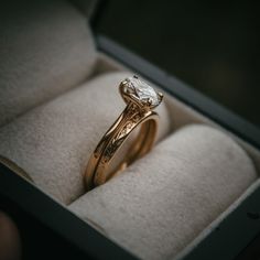 a close up of a ring in a box