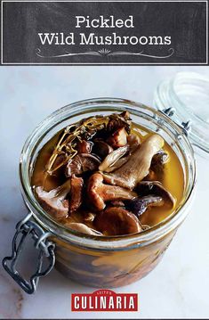 a glass jar filled with food sitting on top of a white counter next to a spoon