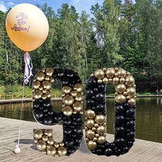 a large balloon that is shaped like the word boo spelled out in gold and black