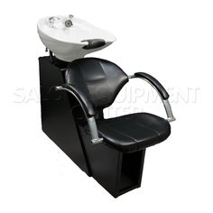 a white sink sitting on top of a black hair dryer chair next to a faucet