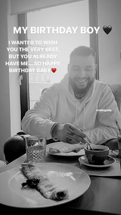 a man sitting at a table with food in front of him and a cup of coffee