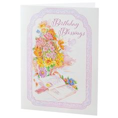 a birthday card with flowers and an open book