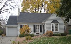 a gray house with black shutters and white trim