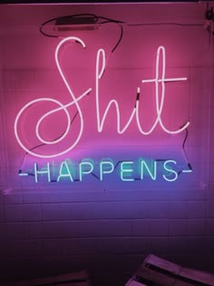 a neon sign that says chill happens on the side of a white wall with pink and blue lights