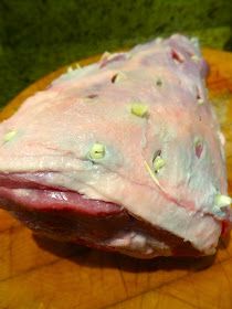 a piece of meat sitting on top of a wooden cutting board