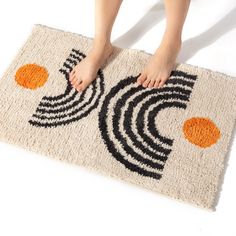 a person standing on a door mat with their feet propped up against the area rug