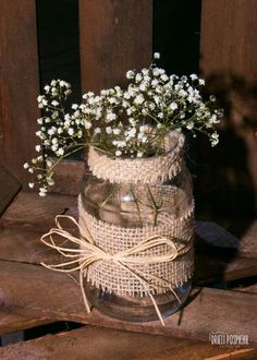 a mason jar filled with baby's breath flowers