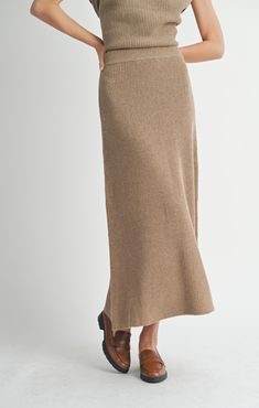 Get ready to jazz up your fall wardrobe with the Crosby Sweater Midi Skirt! This beautiful dark taupe skirt is perfect for those chilly autumn days, with its midi length and cozy sweater material. The elastic waist ensures a comfortable fit, while the ribbed detailing adds a touch of texture. It's a must-have for any fashion-forward individual! Midi length Ribbed knit 100% polyester Midi Sweater Skirt, Ribbed Knit Fabric, Shady Lady, Aline Skirt, Dark Taupe, Vintage Havana, Sweater Material, Sweater Blouse, Cami Tanks