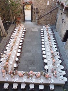 an overhead view of a long table set up for a formal function in the courtyard