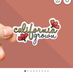 the california grown sticker is being held up by someone's hand and it says,