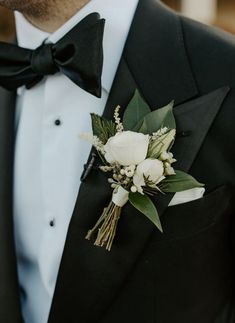 a man in a tuxedo with a boutonniere on his lapel